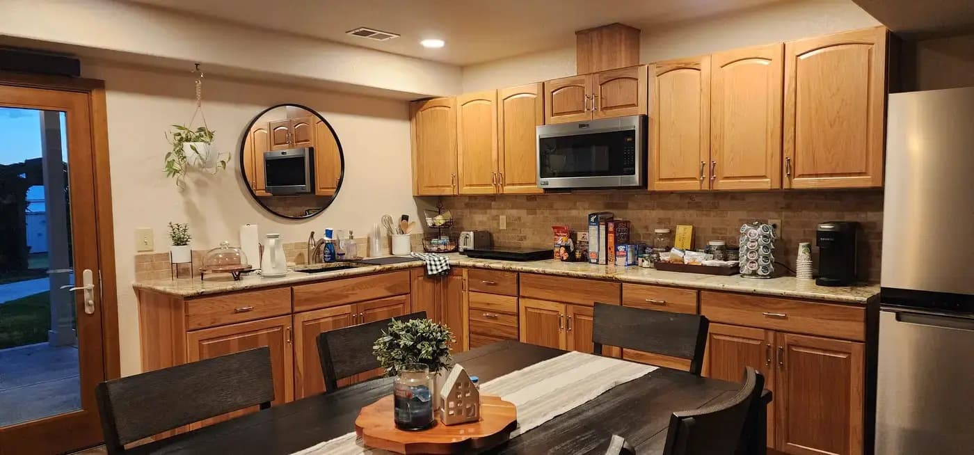 Denver Guest House kitchen with wood cabinetry and granite countertops available to guests
